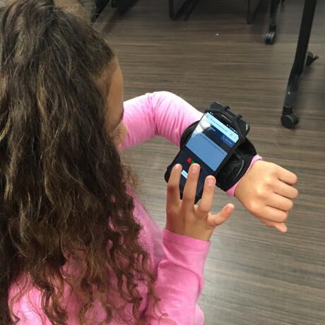 girl playing a WLCP game on her phone